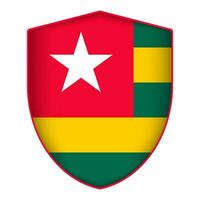 Togo flag in shield shape. Vector illustration.