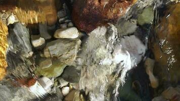 Stones under the transparency of flowing water video