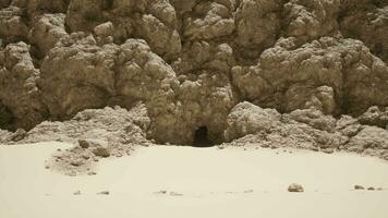 A large rock formation in the middle of a desert video