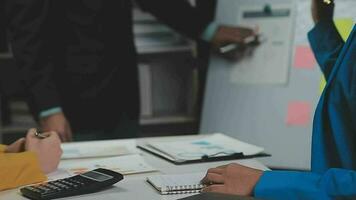 Business team meeting present, investor colleagues consultation and conference new strategy plan business and market growth on financial document graph report, Meeting and Talking. video