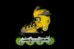 yellow inline skate on a black background photo