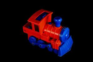 a toy train on a black background photo