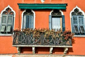 an orange building with a balcony photo