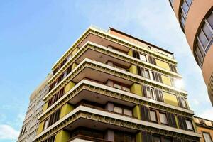 a tall building with a green and yellow facade photo