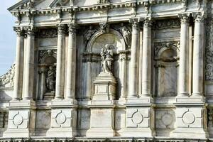 the facade of a building with statues on it photo