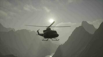 A helicopter is flying over a mountain range video