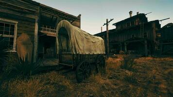 An old covered wagon in front of a historic building video