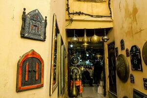a narrow alley with many different types of art on the walls photo