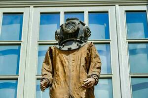 a statue of a man wearing a diving suit photo