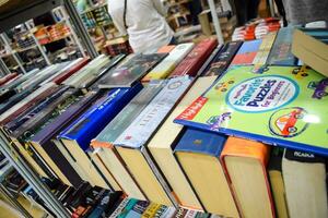 New Delhi, India, September 09 2023 - Variety of Books on shelf inside a book-stall at Delhi International Book Fair, Selection of books on display in Annual Book Fair. photo