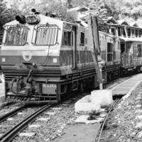 Shimla, Himachal Pradesh, India - August 14, 2023 - Toy train Kalka-Shimla route, moving on railway to the hill, Toy train from Kalka to Shimla in India among green natural forest photo