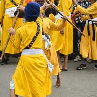 Delhi, India, October 2, 2023 - Sikhs display gatka and martial arts during annual Nagar Kirtan, Traditional, procession on account of birthday of Guru Nanak Dev ji, Nagar Kirtan in East Delhi area photo