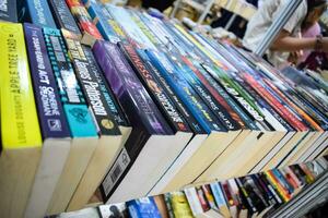 New Delhi, India, September 09 2023 - Variety of Books on shelf inside a book-stall at Delhi International Book Fair, Selection of books on display in Annual Book Fair. photo