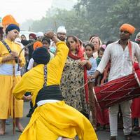 Delhi, India, October 2, 2023 - Sikhs display gatka and martial arts during annual Nagar Kirtan, Traditional, procession on account of birthday of Guru Nanak Dev ji, Nagar Kirtan in East Delhi area photo