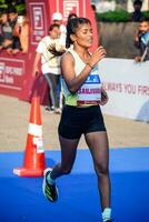 New Delhi, India - October 15 2023 - Vedanta Delhi Half Marathon race after covid in which marathon participants about to cross the finish line, Delhi Half Marathon 2023 photo