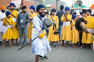 Delhi, India, October 2, 2023 - Sikhs display gatka and martial arts during annual Nagar Kirtan, Traditional, procession on account of birthday of Guru Nanak Dev ji, Nagar Kirtan in East Delhi area photo