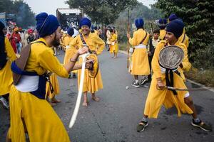 Delhi, India, October 2, 2023 - Sikhs display gatka and martial arts during annual Nagar Kirtan, Traditional, procession on account of birthday of Guru Nanak Dev ji, Nagar Kirtan in East Delhi area photo