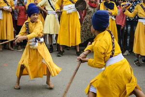 Delhi, India, October 2, 2023 - Sikhs display gatka and martial arts during annual Nagar Kirtan, Traditional, procession on account of birthday of Guru Nanak Dev ji, Nagar Kirtan in East Delhi area photo