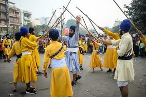 Delhi, India, October 2, 2023 - Sikhs display gatka and martial arts during annual Nagar Kirtan, Traditional, procession on account of birthday of Guru Nanak Dev ji, Nagar Kirtan in East Delhi area photo