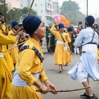 Delhi, India, October 2, 2023 - Sikhs display gatka and martial arts during annual Nagar Kirtan, Traditional, procession on account of birthday of Guru Nanak Dev ji, Nagar Kirtan in East Delhi area photo