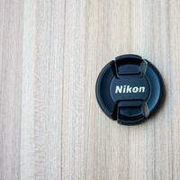 New Delhi, India, October 8 2023 - Nikon lens cap on plain background, Nikon DSLR kit shoot photo