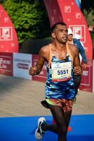 New Delhi, India - October 15 2023 - Vedanta Delhi Half Marathon race after covid in which marathon participants about to cross the finish line, Delhi Half Marathon 2023 photo