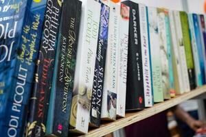 New Delhi, India, September 09 2023 - Variety of Books on shelf inside a book-stall at Delhi International Book Fair, Selection of books on display in Annual Book Fair. photo