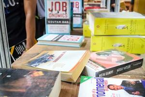 New Delhi, India, September 09 2023 - Variety of Books on shelf inside a book-stall at Delhi International Book Fair, Selection of books on display in Annual Book Fair. photo