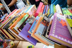 New Delhi, India, September 09 2023 - Variety of Books on shelf inside a book-stall at Delhi International Book Fair, Selection of books on display in Annual Book Fair. photo