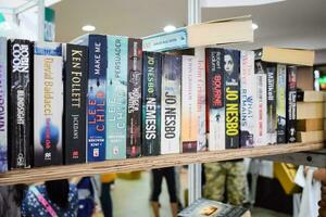 New Delhi, India, September 09 2023 - Variety of Books on shelf inside a book-stall at Delhi International Book Fair, Selection of books on display in Annual Book Fair. photo