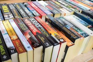 New Delhi, India, September 09 2023 - Variety of Books on shelf inside a book-stall at Delhi International Book Fair, Selection of books on display in Annual Book Fair. photo