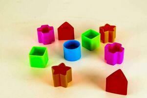 a group of colorful plastic blocks arranged on a surface photo