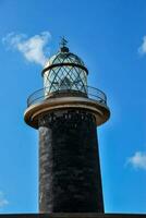 a lighthouse against a blue sky photo