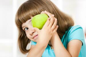 Little girl holding apple photo