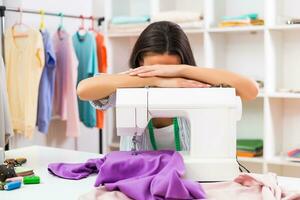 Tired seamstress at her workshop. photo