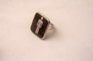 a ring with a man on it sitting on a table photo