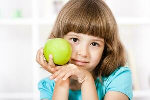 Little girl holding apple photo