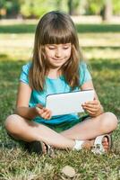 Little girl with digital tablet photo