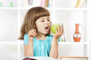 Little girl heating apple photo