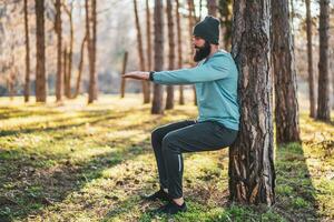 Man with beard enjoys exercising in nature photo