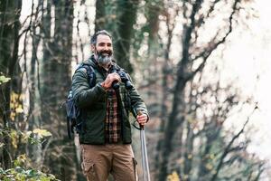 Image of man hiking and using binoculars photo