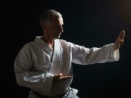 Senior man practicing karate photo