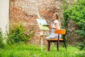 mujer disfruta mujer pintura en lona al aire libre foto