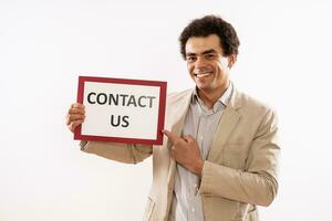Image of businessman holding paper with text contact us photo