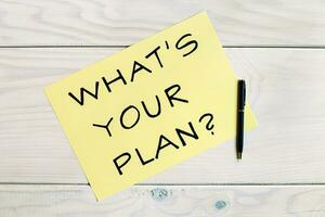 Question what's your plan with pen on wooden table photo