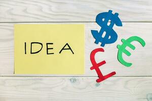 Idea concept with euro currency notes on wooden background photo