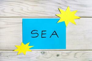 Sea concept on wooden background photo