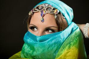 Close up portrait of belly dancer wrapped in veil photo