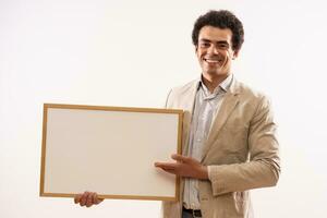 Portrait of businessman showing whiteboard photo