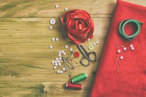 Sewing accessories on wooden table photo